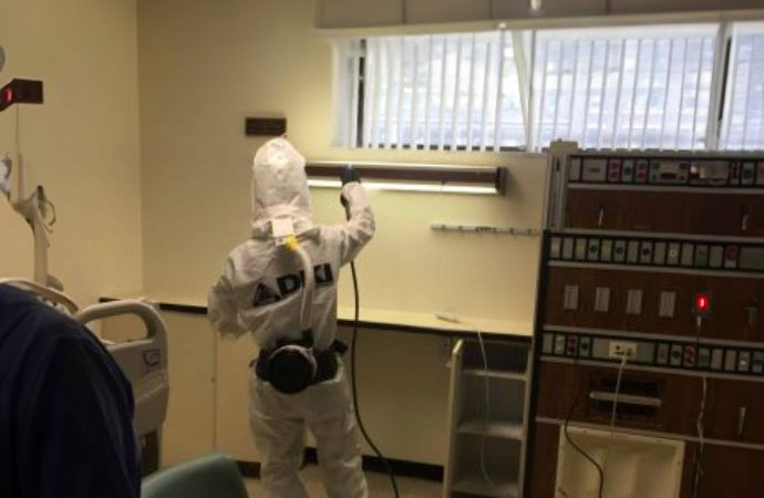 Person in protective gear working on infection control